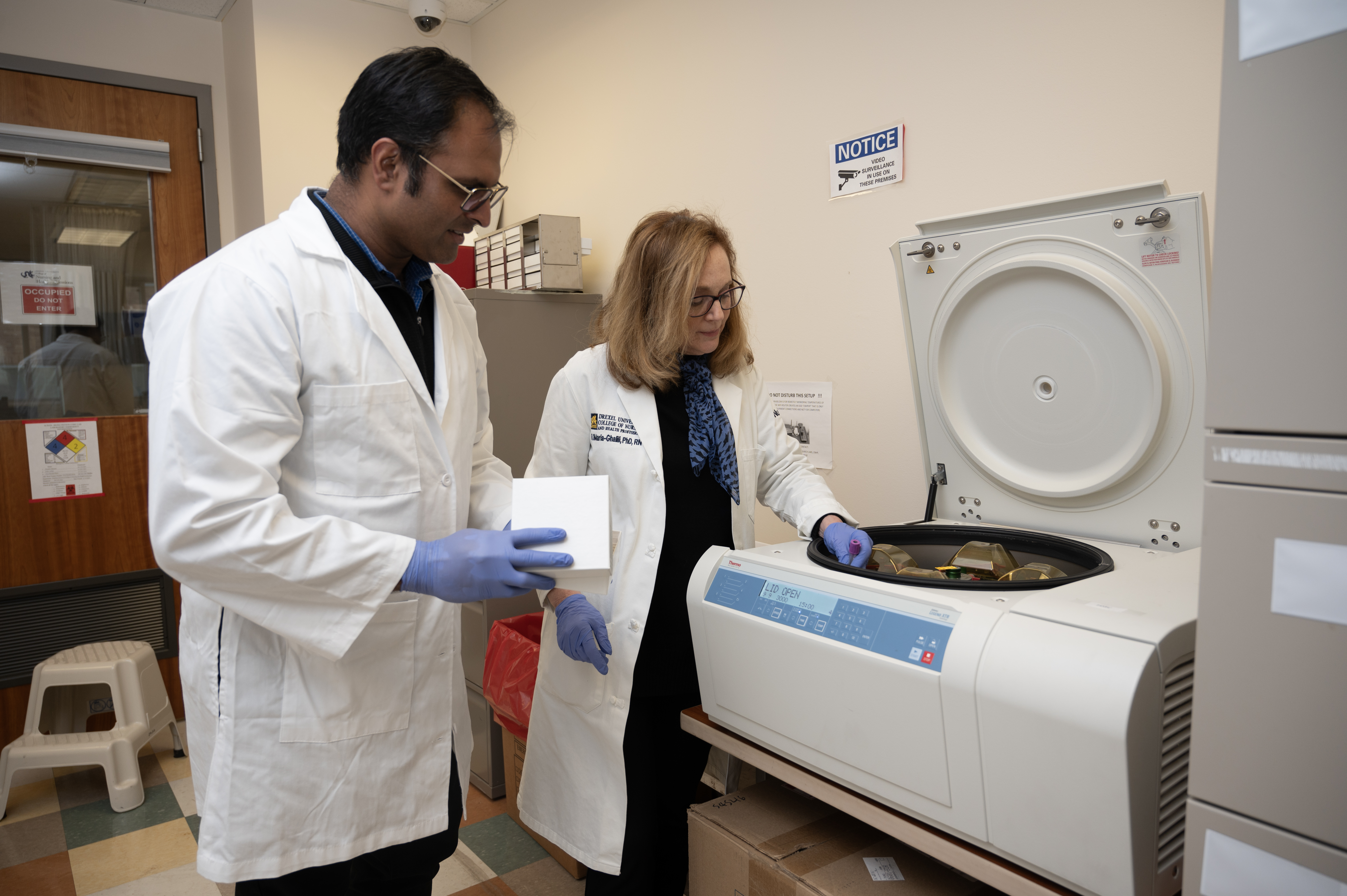 Students work with lab machinery